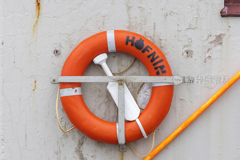 lifebuoy along the quay of the harbor in the Icelandic port of Höfn